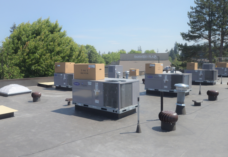 Completed TPO flat roof with rooftop HVAC units and ventilation