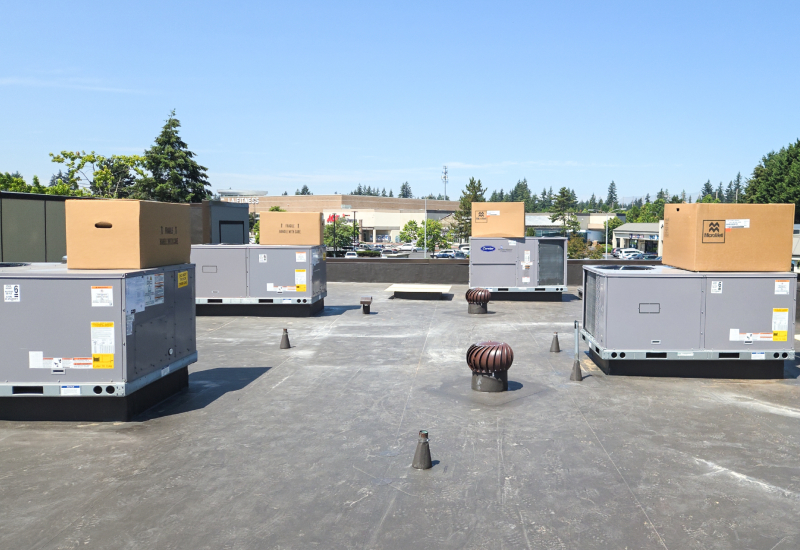 Commercial flat roof showing TPO roofing around HVAC units and roof penetrations