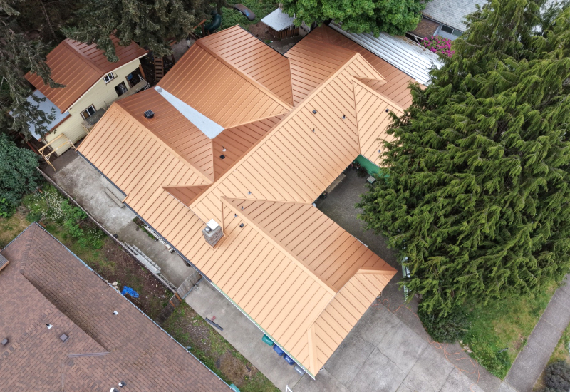 Overhead view of Imperial Metals standing seam roofing in Copper Penny on the main residence and additional buildings