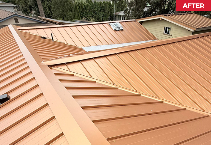 Completed Imperial Metals standing seam roof in Copper Penny showing the newly installed metal panels and intersecting rooflines