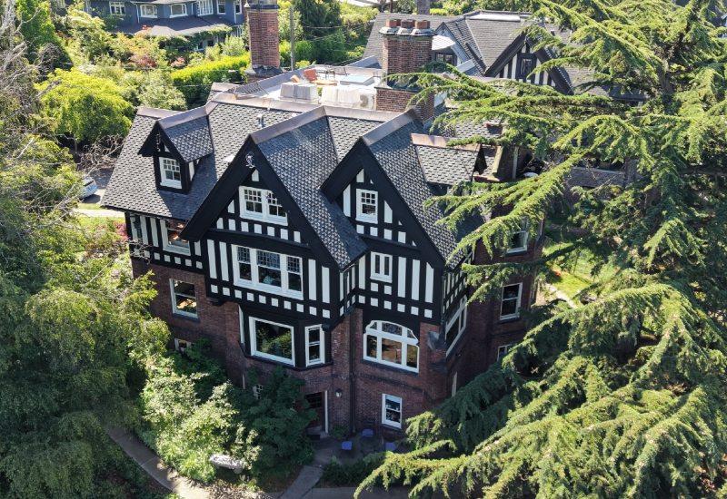 Aerial view of the Historic Fisher Mansion featuring Owens Corning Woodmoor shingles in Granite and custom copper roofing details