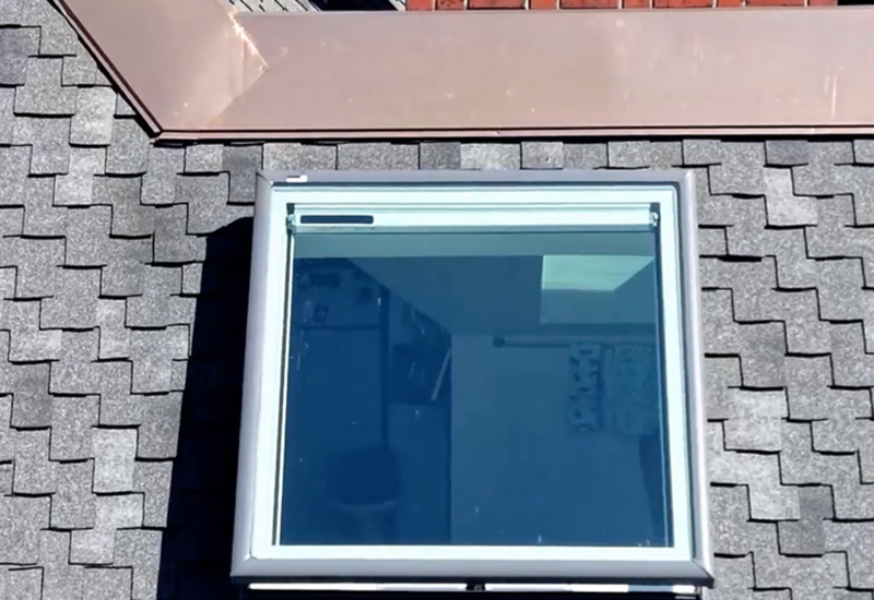 ew skylight installed on the shingle roof to bring natural light into the third-floor kitchenette