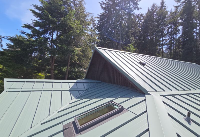 Close-up of standing seam metal roofing, showing clean panel lines and custom metal flashing.