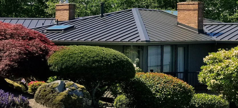 ROOF BOSS Metal Roof a new dark metal roof installed on a home